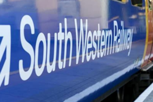 The side of a South Western Railway train, with the logo and name of the train company visible.