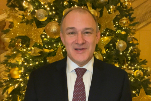 Ed Davey standing in front of a Christmas tree